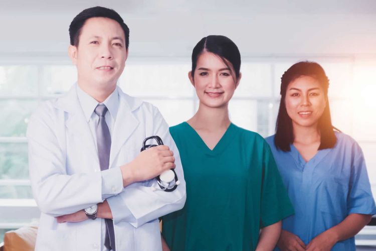 Team Asian doctor and Nurse Standing confident hospital background
